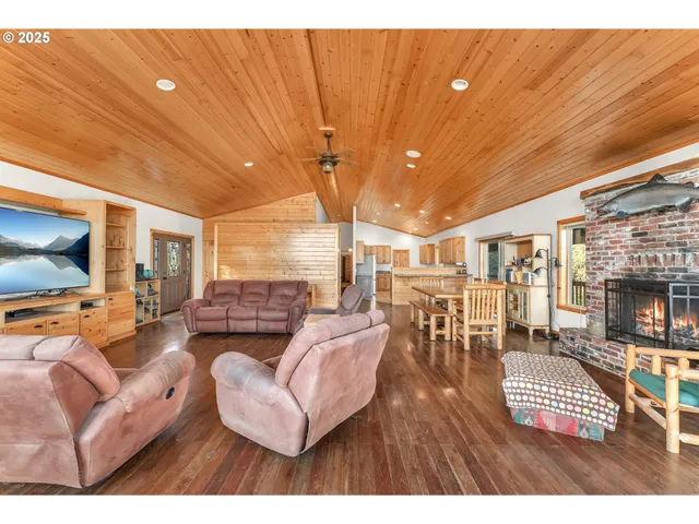 a living room with furniture a fireplace and a table