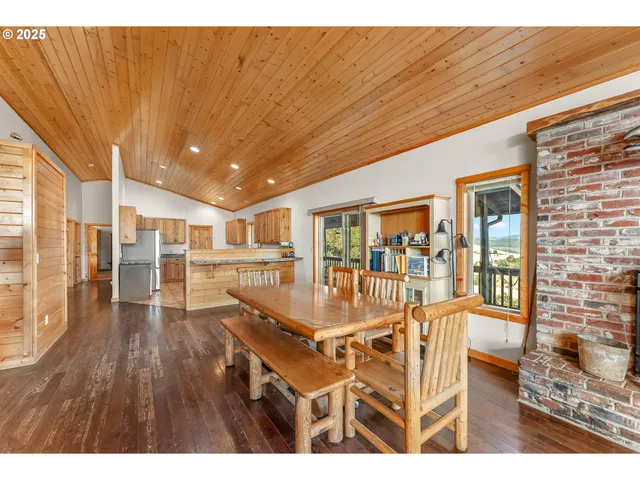 a view of kitchen with stainless steel appliances granite countertop a stove and a refrigerator