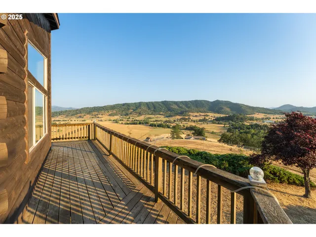 a balcony with wooden floor and outdoor seating