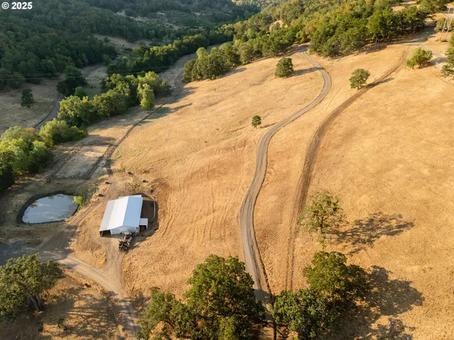a aerial view of a house next to a yard
