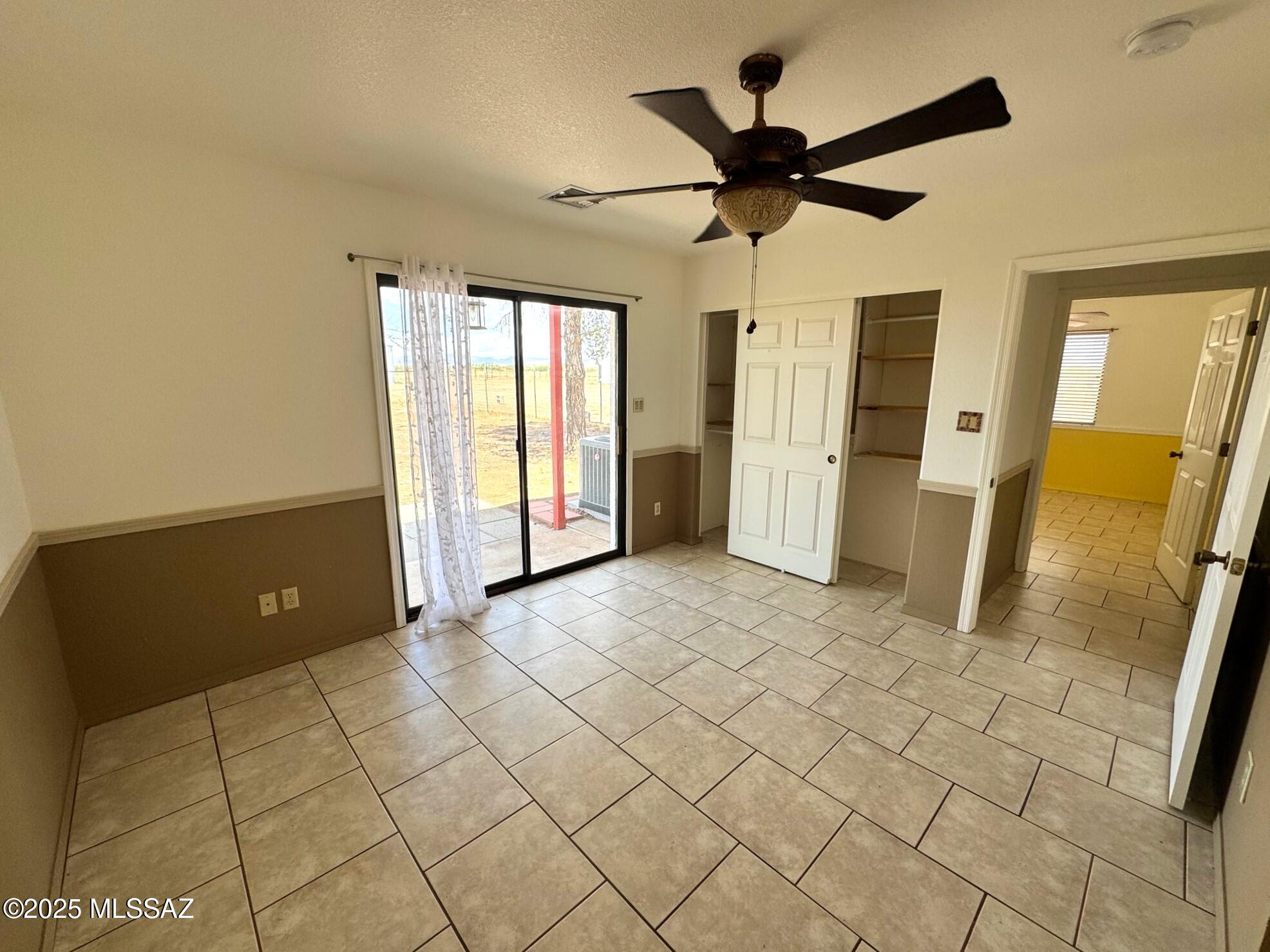 13384 South Cottonwood Road Pearce, AZ 85625 - Photo 21 of 46 a view of a livingroom with a ceiling fan and window