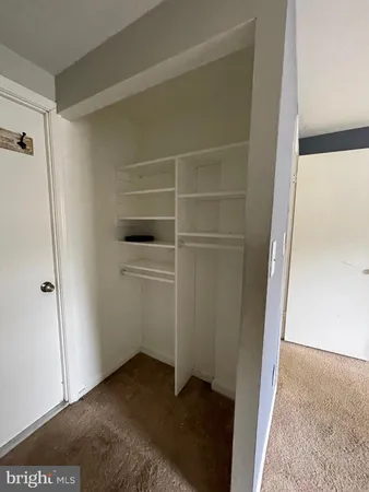 a bathroom with a granite countertop toilet and a sink