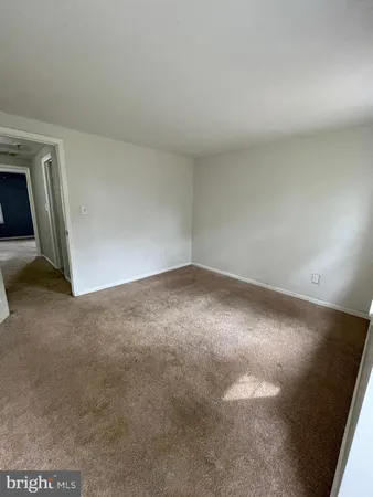 a view of an empty room with closet