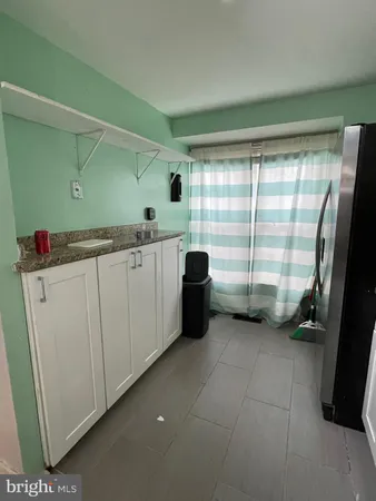 a kitchen with a sink and large cabinets