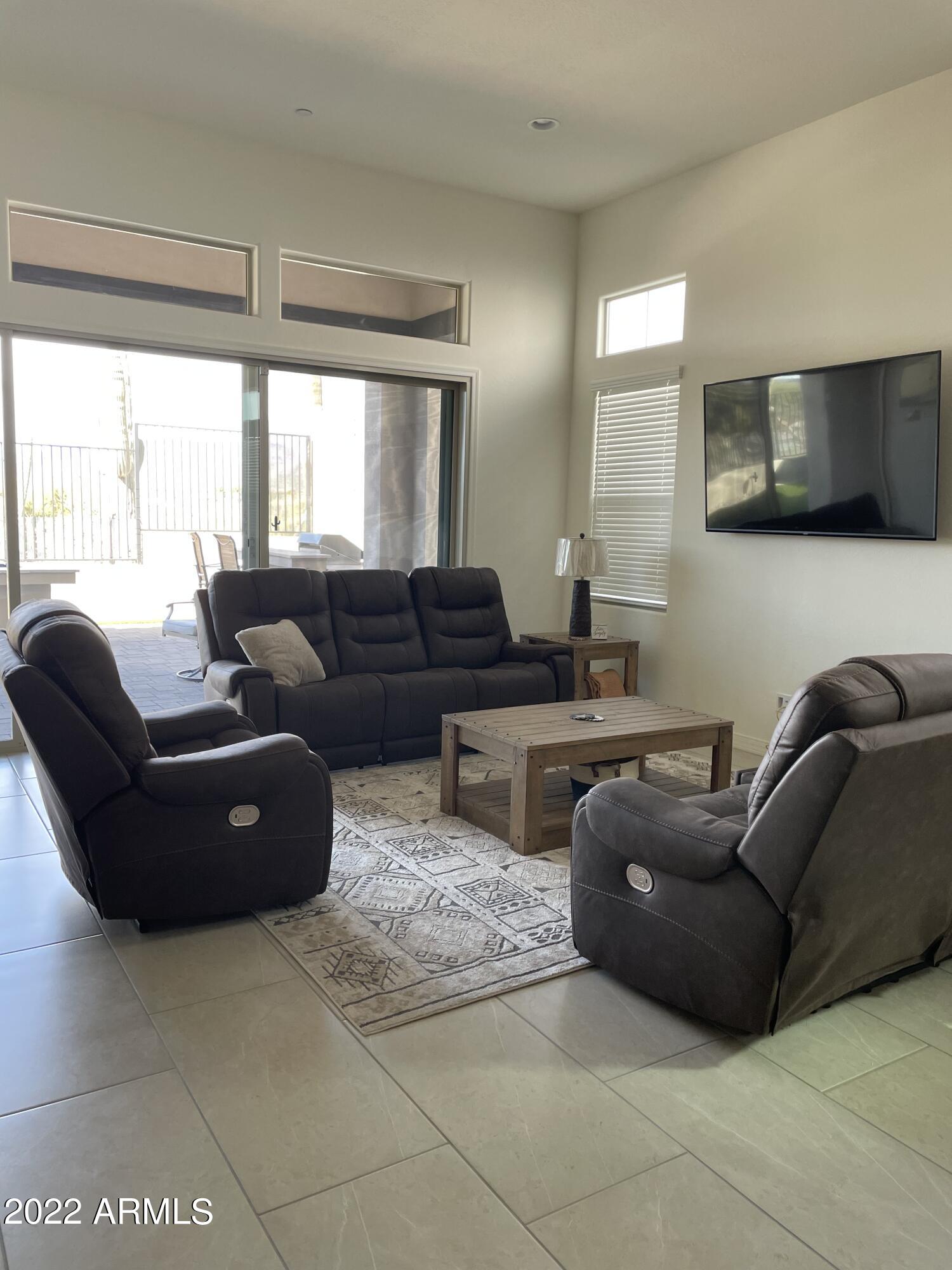 38500 North School House Road, Unit 50 Cave Creek, AZ 85331 - Photo 7 of 17 a living room with furniture and a flat screen tv