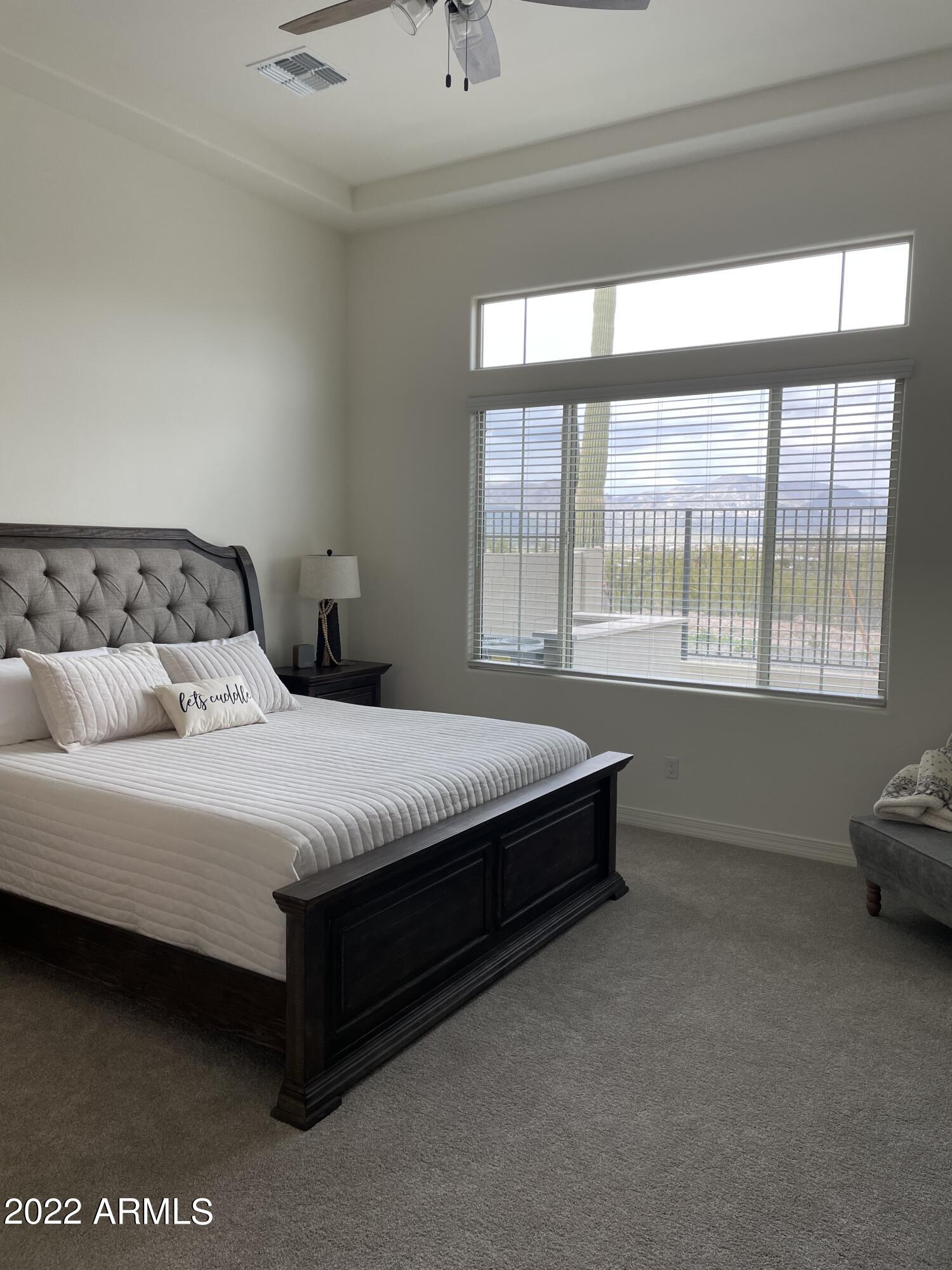 38500 North School House Road, Unit 50 Cave Creek, AZ 85331 - Photo 9 of 17 a bedroom with a bed and window