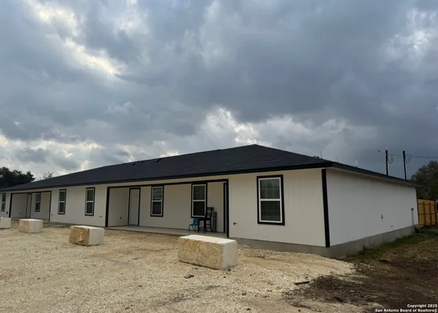 a backyard of a house with shaded area