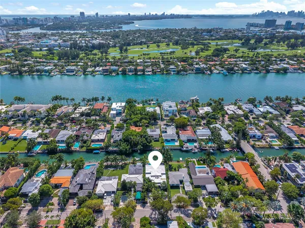 an aerial view of lake and residential houses with outdoor space