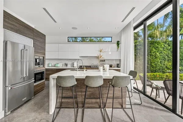 a kitchen with a table chairs and a refrigerator