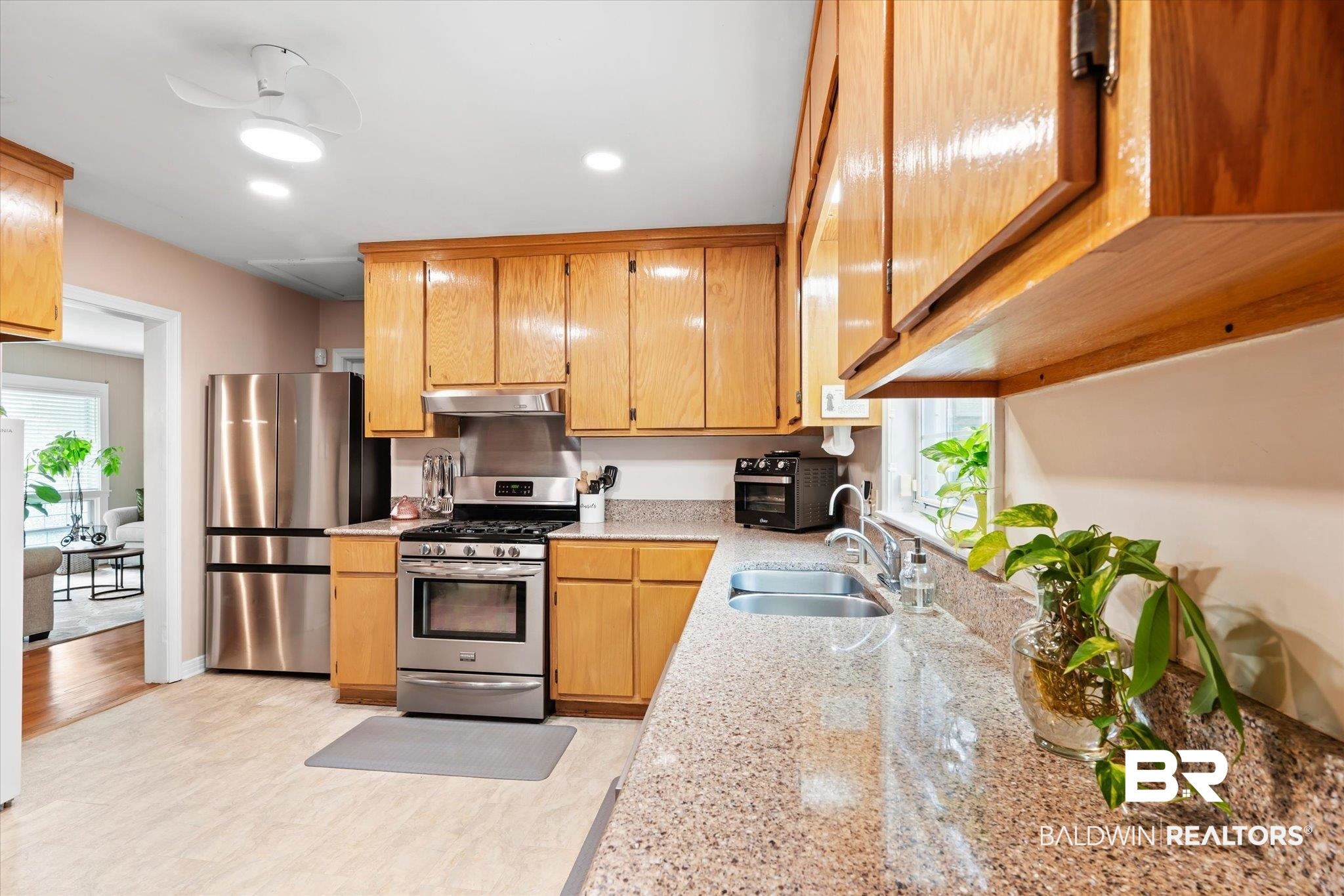 162 Bit And Spur Terrace Mobile, AL 36608 - Photo 6 of 29 Kitchen featuring sink, light hardwood / wood-style floors, stainless steel appliances, and a wealth of natural light