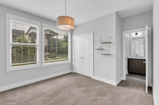 an empty room with cabinet and mirror