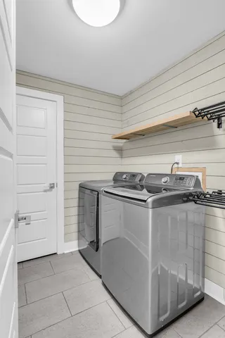 a bathroom with a sink a mirror and wooden floor