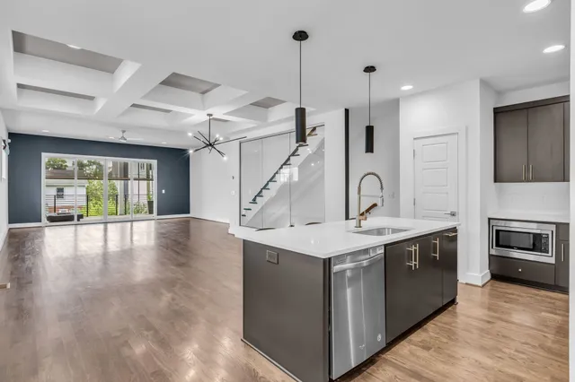 a kitchen with kitchen island a sink stainless steel appliances and cabinets