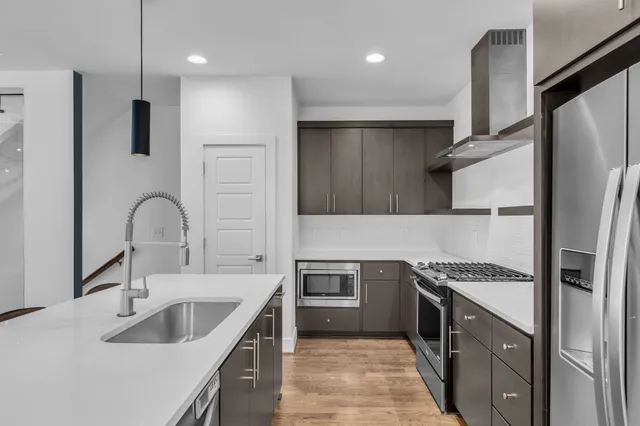 a kitchen with a sink stove and refrigerator
