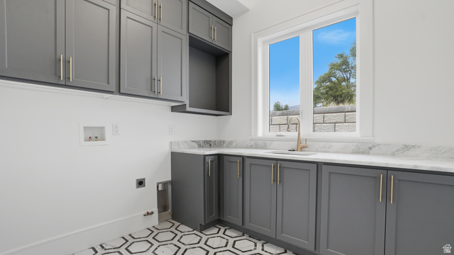 1682 North 1950 W Street, Unit 9 Provo, UT 84604 - Photo 27 of 84 Laundry room featuring gray cabinetry, a white countertop, an undermount sink with a gold-tone faucet, and hexagonal floor tiling