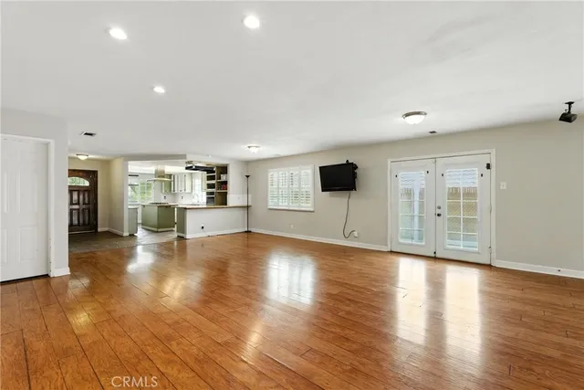 a view of empty room with wooden floor