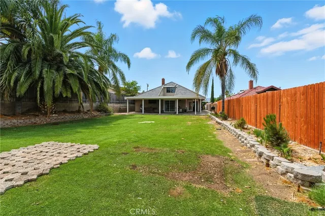 a front view of house with yard and outdoor seating