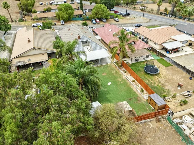 an aerial view of a house with a yard and lake