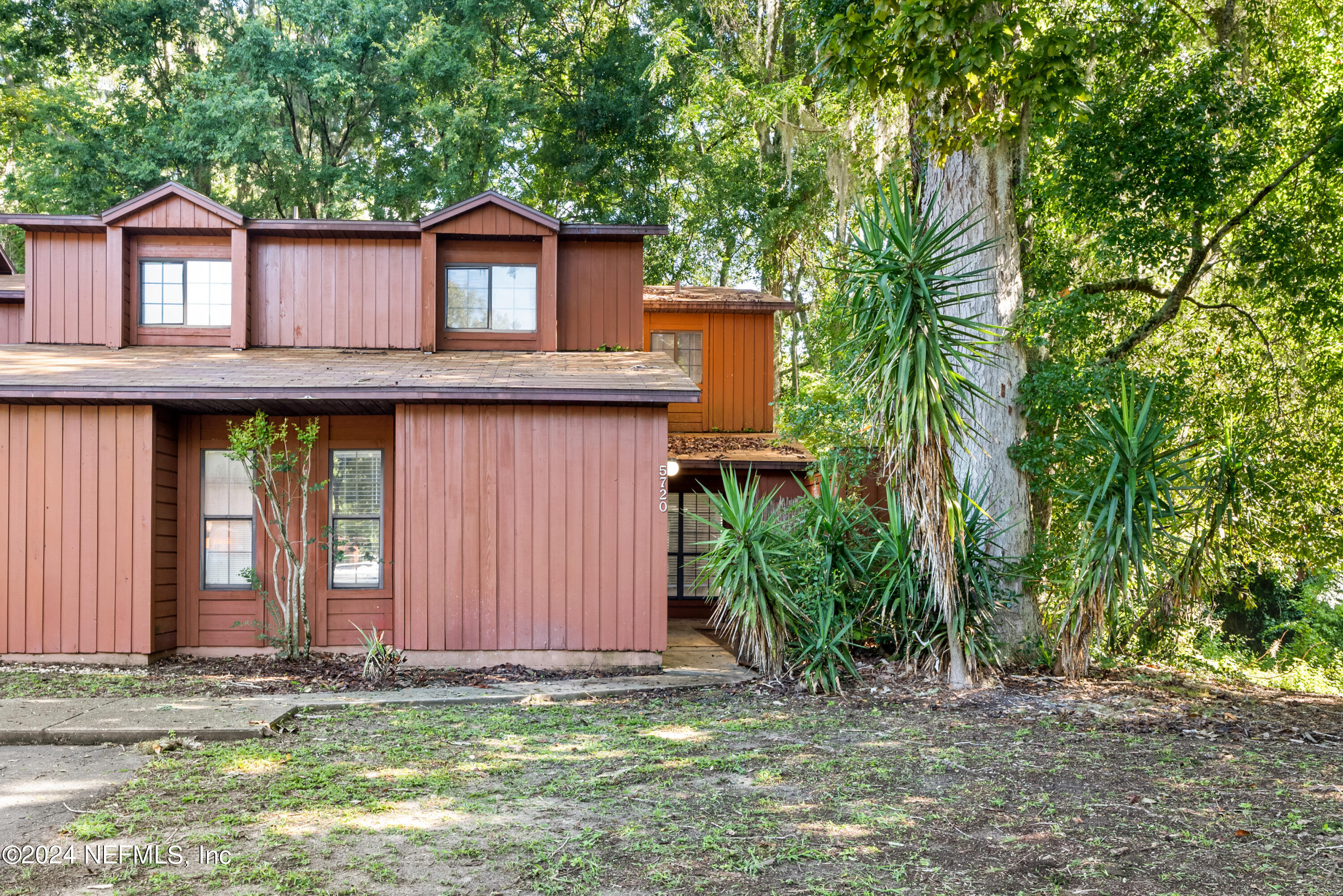 5720 Southwest 8th Place Gainesville, FL 32607 - Photo 1 of 17 a front view of a house with garden