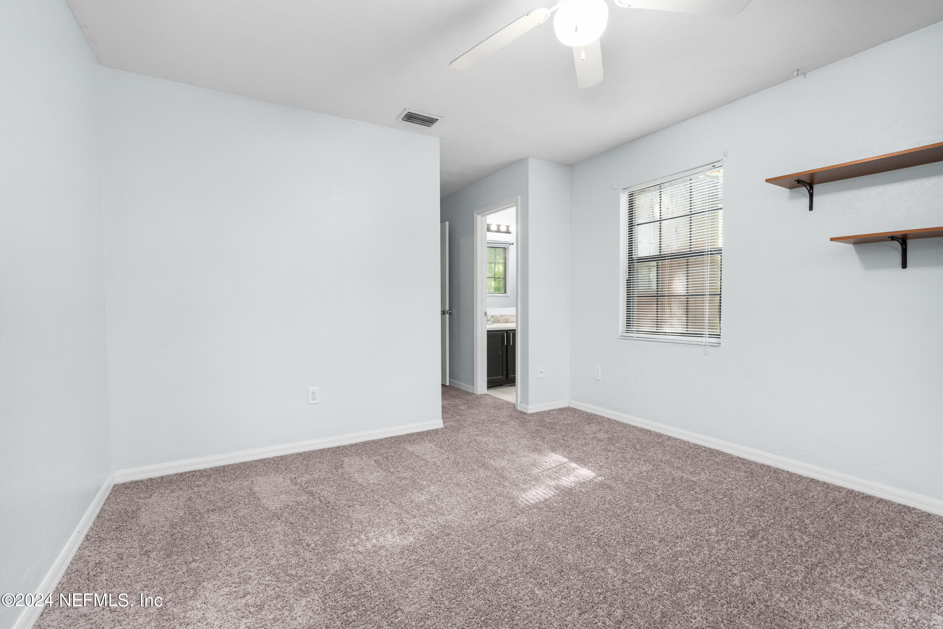 5720 Southwest 8th Place Gainesville, FL 32607 - Photo 11 of 17 an empty room with windows