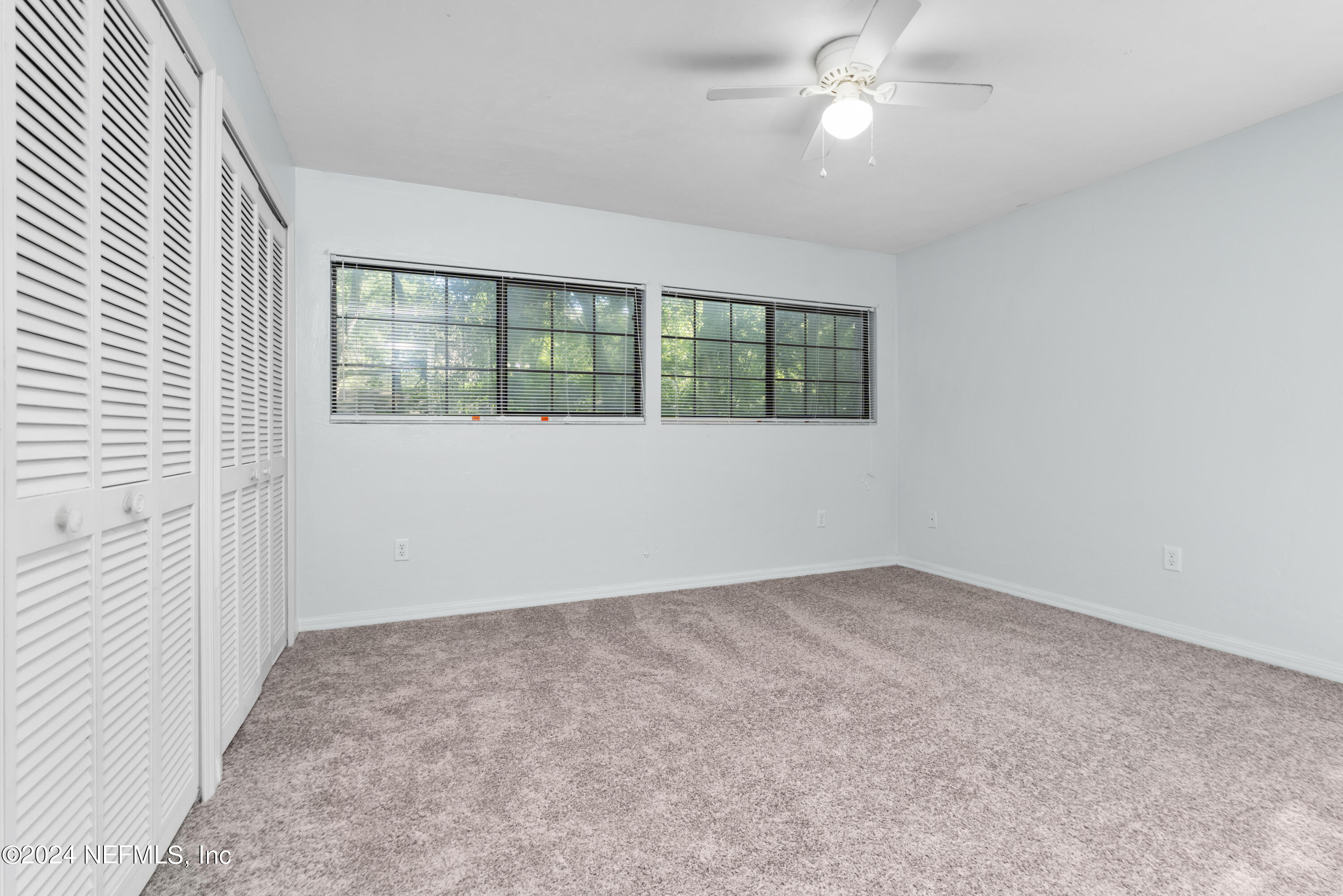 5720 Southwest 8th Place Gainesville, FL 32607 - Photo 13 of 17 an empty room with ceiling fan and window
