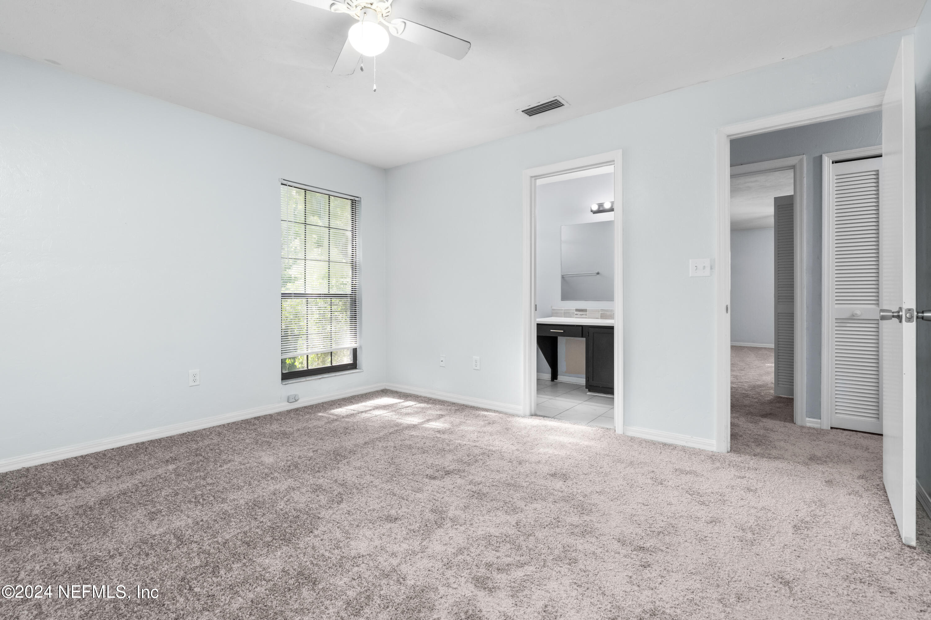 5720 Southwest 8th Place Gainesville, FL 32607 - Photo 14 of 17 an empty room with windows and fireplace