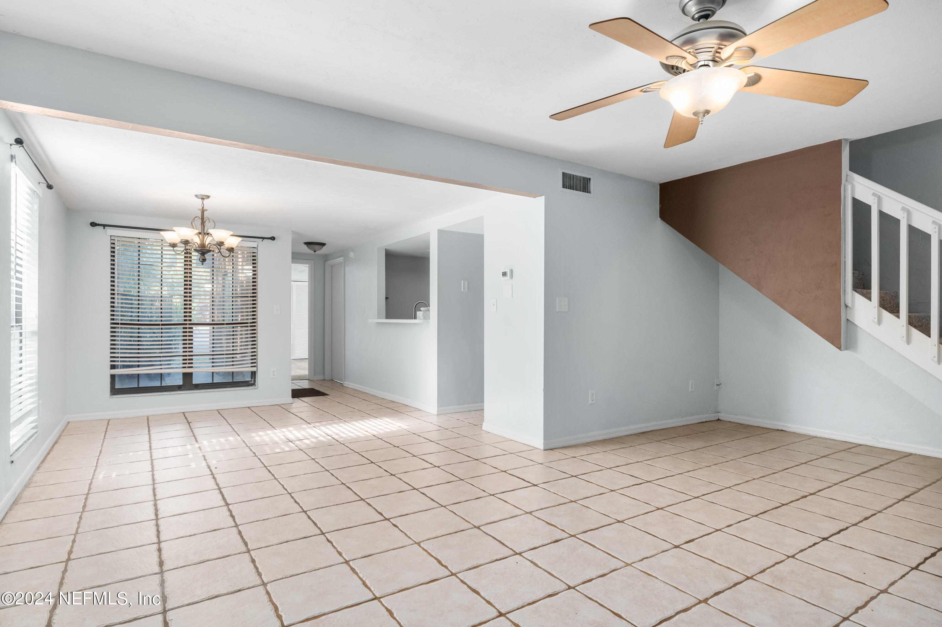 5720 Southwest 8th Place Gainesville, FL 32607 - Photo 4 of 17 a view of an empty room and chandelier fan