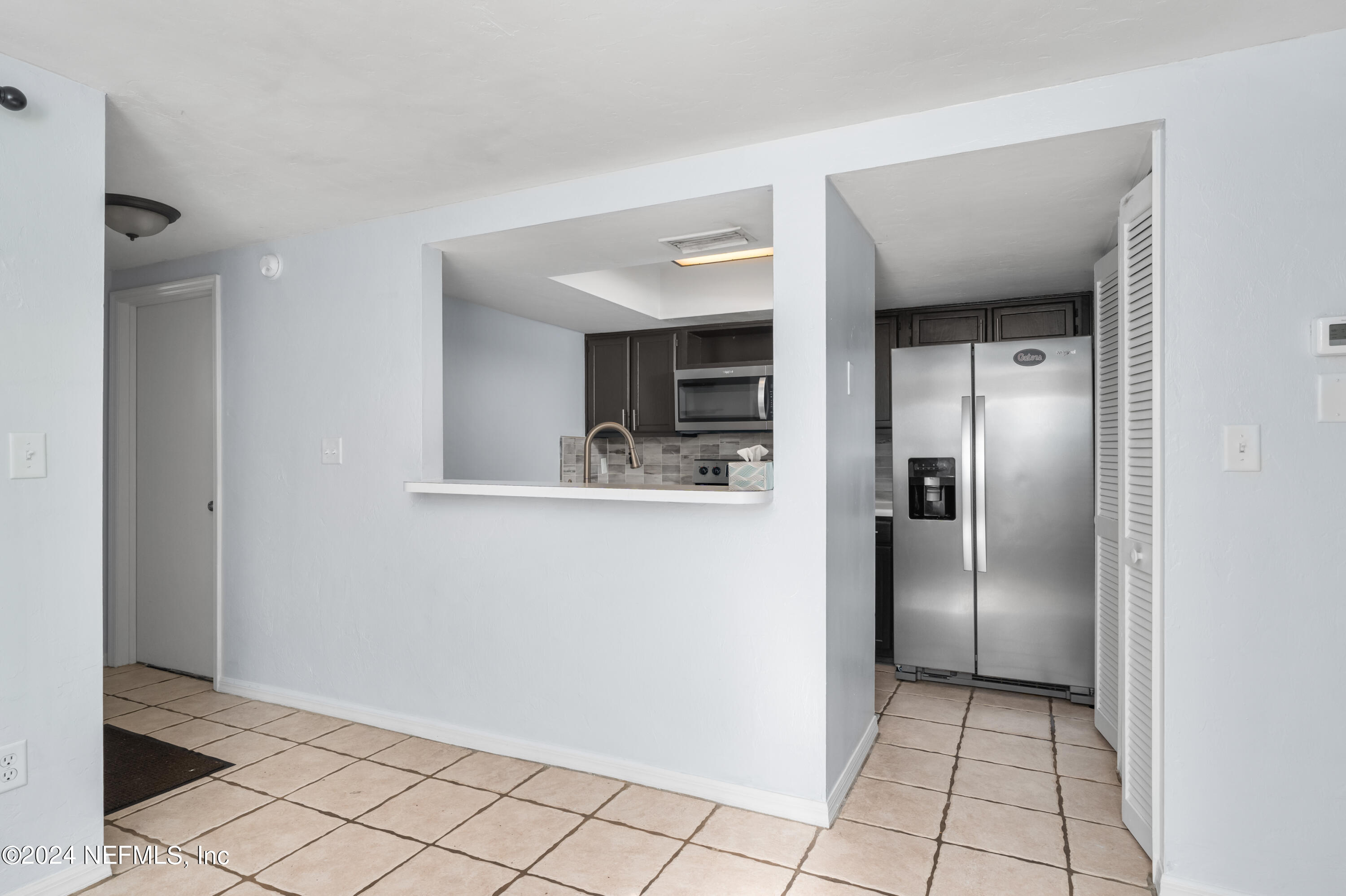 5720 Southwest 8th Place Gainesville, FL 32607 - Photo 5 of 17 a view of a kitchen from the hallway