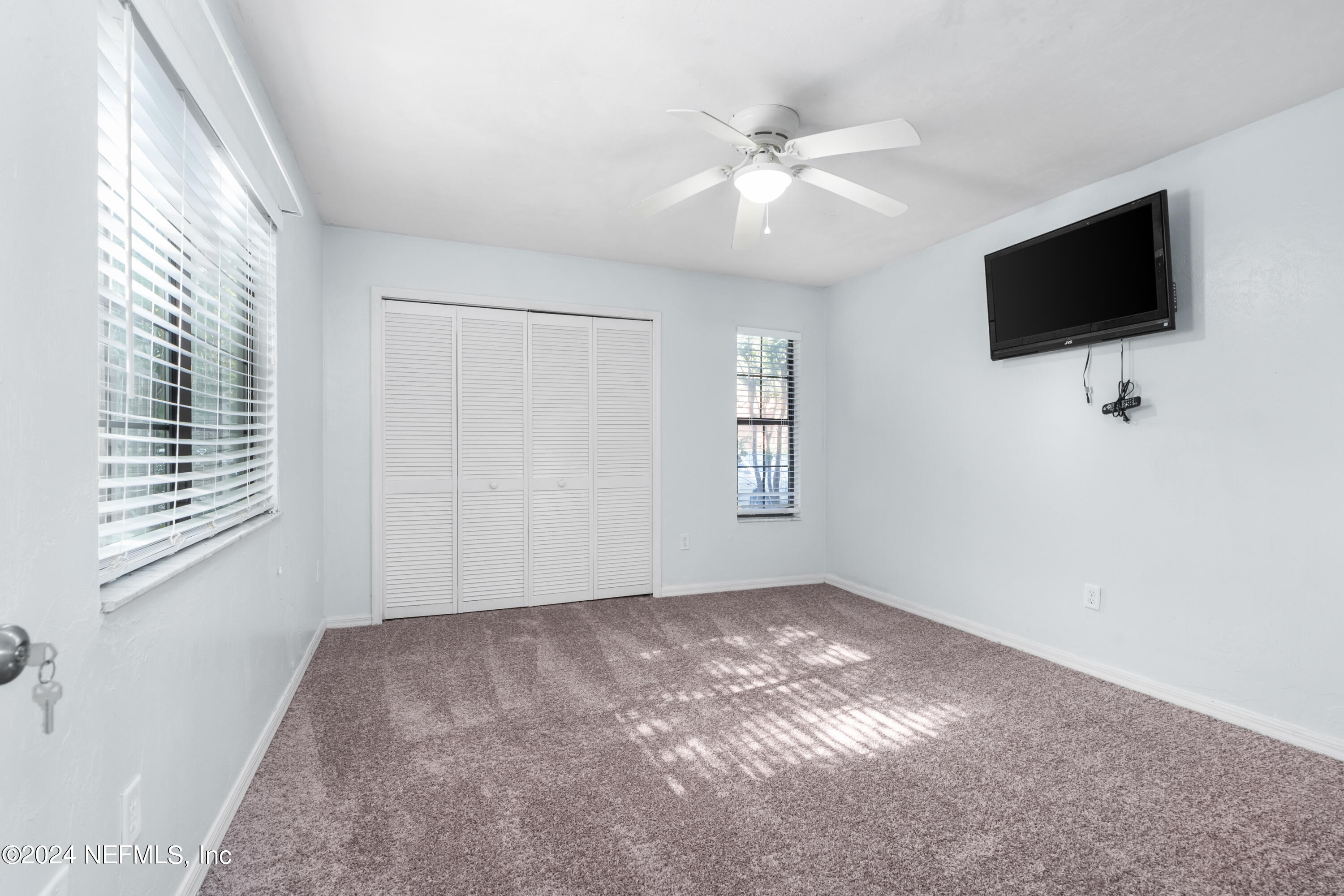 5720 Southwest 8th Place Gainesville, FL 32607 - Photo 8 of 17 a view of livingroom with window flat screen tv and windows