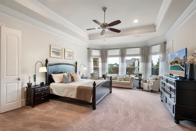 a bedroom with a bed furniture and a large window