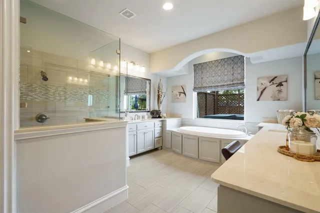 a large white kitchen with a large window