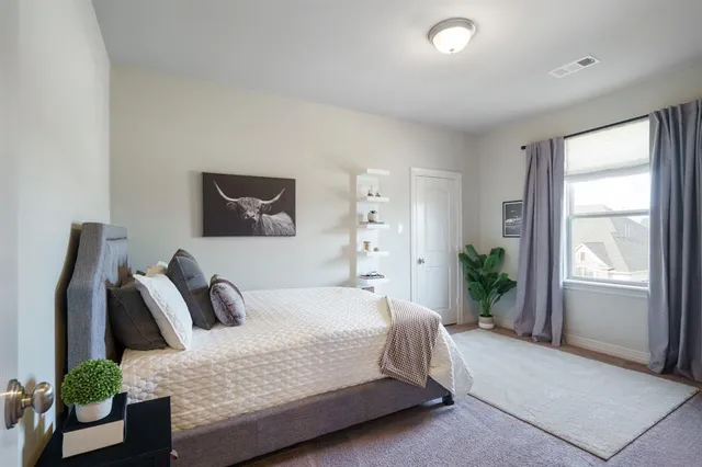 a spacious bedroom with a balcony a bed and a couch