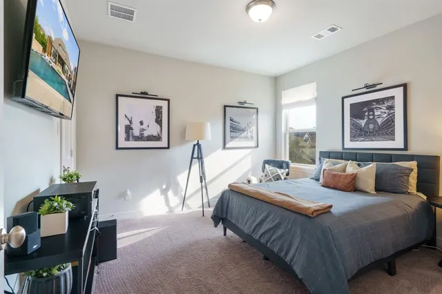 a bedroom with a bed and a desk