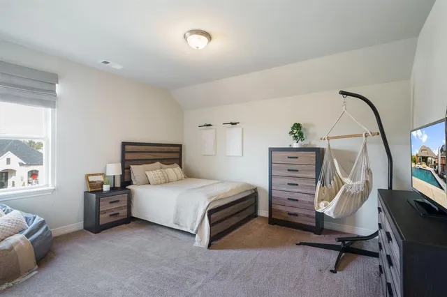 a bedroom with a bed and a chandelier