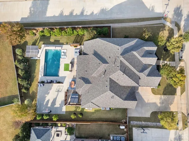 an aerial view of residential houses with outdoor space
