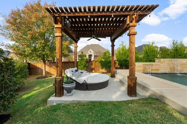 a backyard of a house with table and chairs