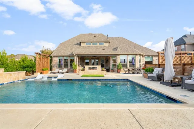 a view of a white house with swimming pool in front of it
