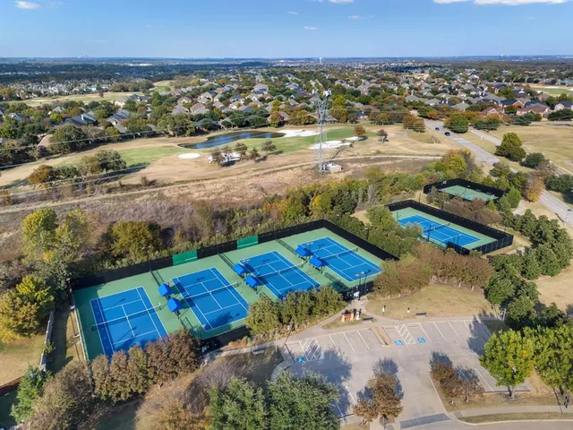 an aerial view of residential houses with outdoor space