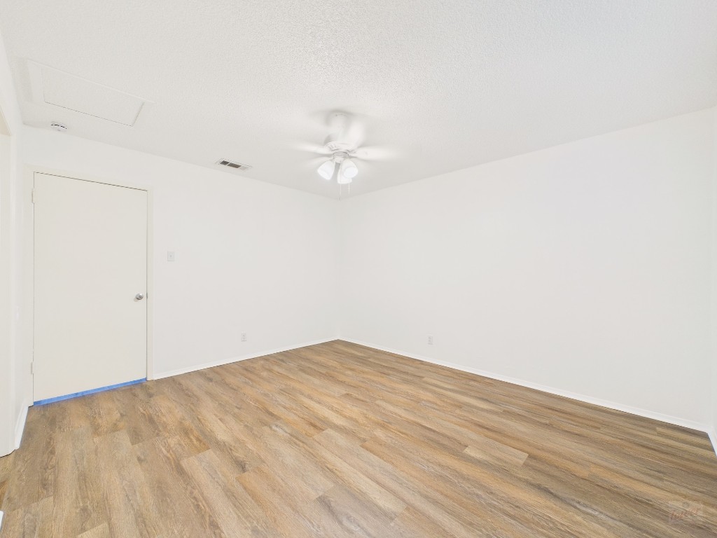1305 Hollow Creek Drive, Unit 4 Austin, TX 78704 - Photo 17 of 21 an empty room with wooden floor and fan