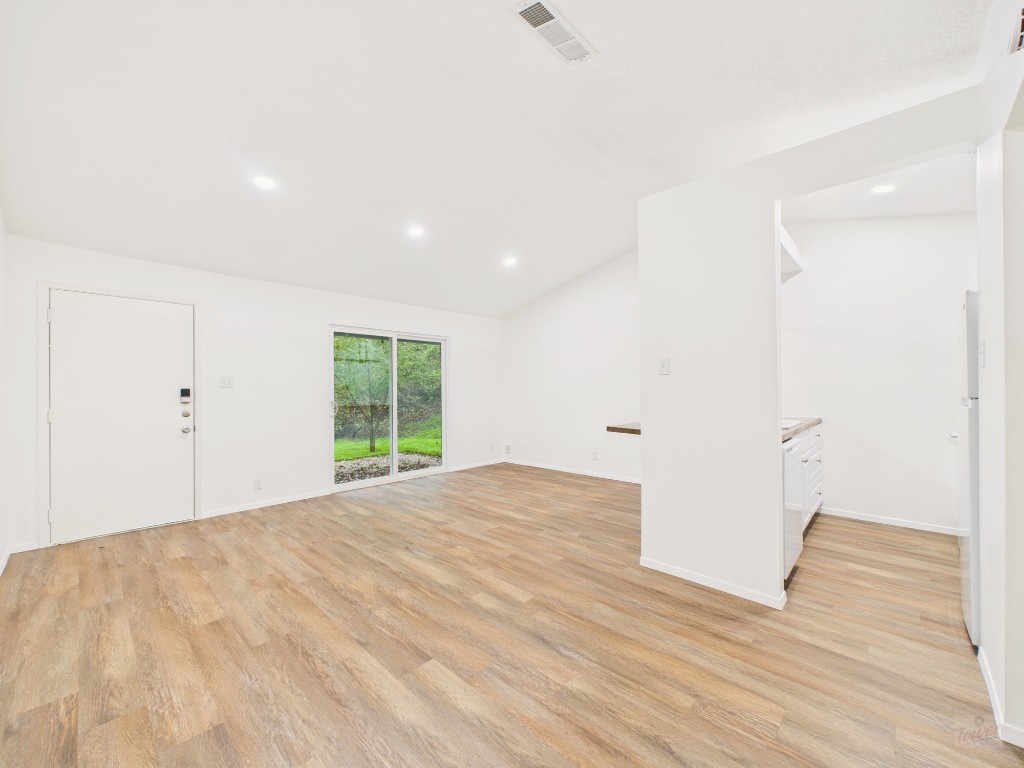 1305 Hollow Creek Drive, Unit 4 Austin, TX 78704 - Photo 2 of 21 a view of an empty room with wooden floor and a window