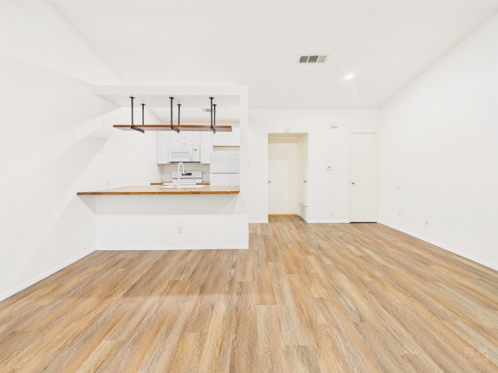 1305 Hollow Creek Drive, Unit 4 Austin, TX 78704 - Photo 4 of 21 a view of a kitchen with wooden floor