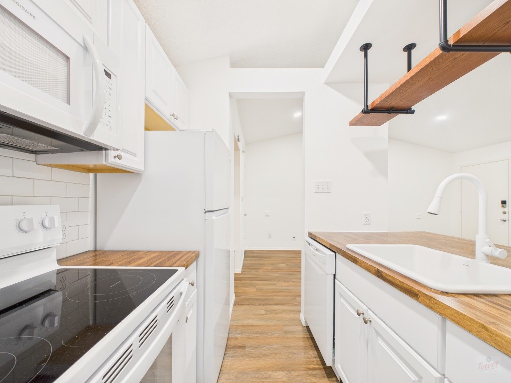 1305 Hollow Creek Drive, Unit 4 Austin, TX 78704 - Photo 7 of 21 a bathroom with a granite countertop sink and white cabinets