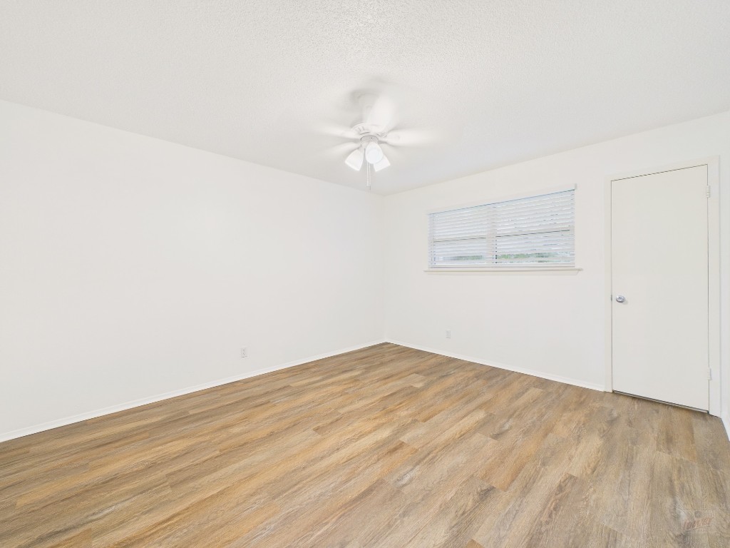1305 Hollow Creek Drive, Unit 4 Austin, TX 78704 - Photo 8 of 21 an empty room with a fan & a ceiling fan