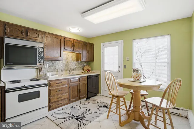 a kitchen with stainless steel appliances kitchen island granite countertop a sink and cabinets