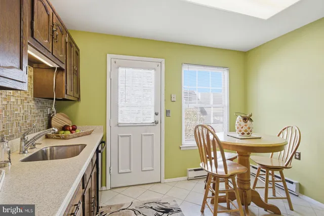 a dining room with furniture and a sink