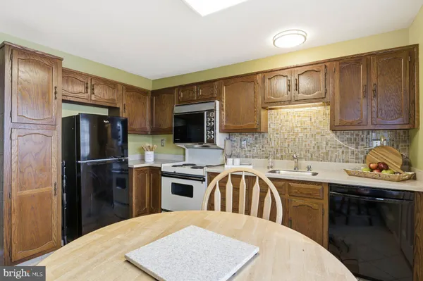 a kitchen with a sink stove and refrigerator