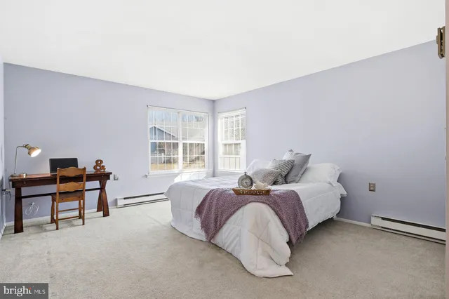 a bed room with a bed and a desk