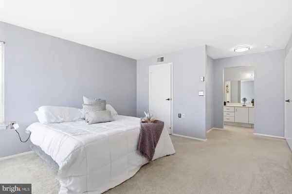 a bedroom with a bed and a couch