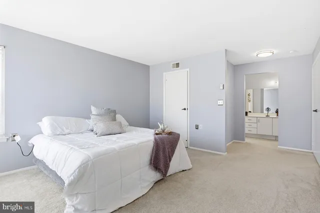 a bedroom with a bed and a couch