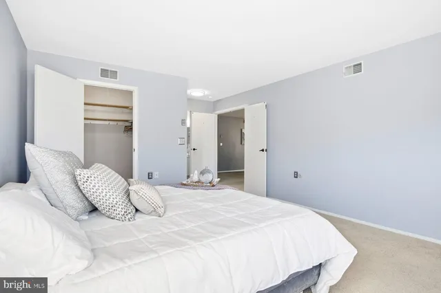 a bedroom with a bed and cabinets